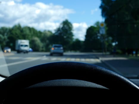 view from behind the steering wheel of a car first-person view