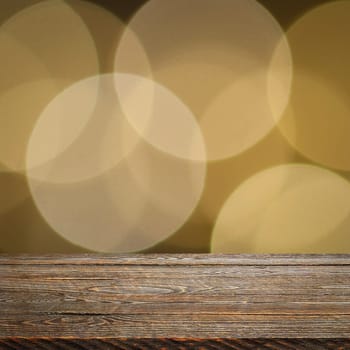 The background is an empty wooden board and a wall of blurred bokeh lights. For product demonstrations, free space, layout, mockup, perspective board, background board.