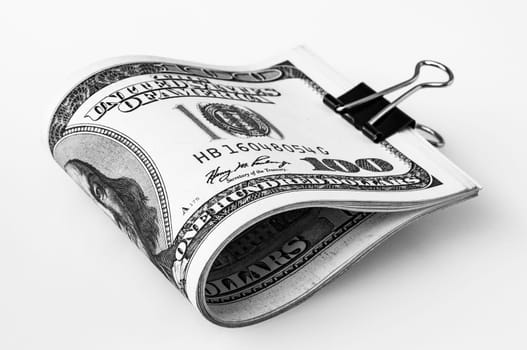 A stack of packaged dollars on a white background. One hundred American dollar bills. The pile of dollars is isolated with a shadow. Black and white style. A big wad of dollars. Place for logo, lettering, layout, layout.