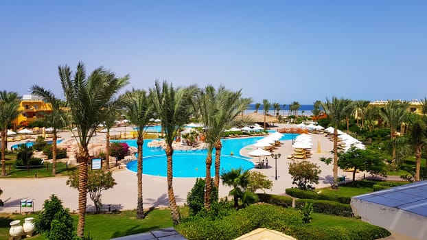 Sharm El Sheikh, Egypt - July 13, 2019: main pool and Amway territory. Luxurious hotel grounds. Landscaping and pool with sun loungers overlooking the sea. Hotel and spa in Sharm El Sheikh in Egypt.
