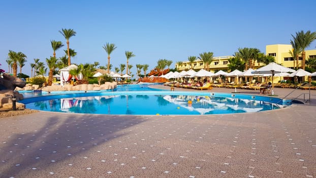 Sharm El Sheikh, Egypt - July 13, 2019: main pool and Amway territory. Luxurious hotel grounds. Landscaping and pool with sun loungers overlooking the sea. Hotel and spa in Sharm El Sheikh in Egypt.