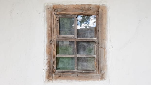 Ukraine, Kiev - June 11, 2020. Old window in a vintage traditional peasant house in Ukraine. Antique wooden window frame. Pirogovo National Museum in the open air in Kiev. Copy space