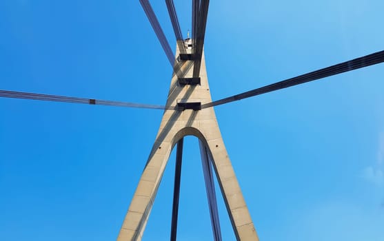 Ukraine, Kiev - August 20, 2019: A bridge across the river with pulling ropes. North bridge against the backdrop of a beautiful simple blue sky without clouds in Kiev. R. Dnieper. Ukraine. Scenery