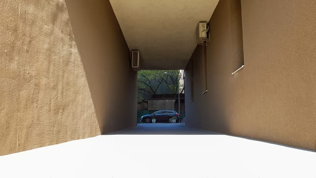 Entrance between two houses in a residential courtyard, the street of the historical center of Kiev. Architecture.