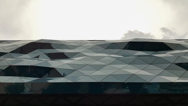 Ukraine, Kiev - June 1, 2020: facade of a curved glass building. modern architecture. Unusual design of the shopping center.