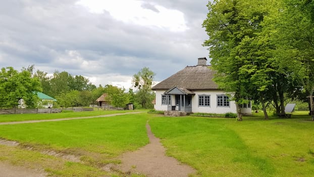 Ukraine, Kiev - June 11, 2020. The old house of peasants in the museum Pirogovo. National Museum of Folk Architecture and Everyday Life of Traditional Folklore Houses of Different Regions of Ukraine.