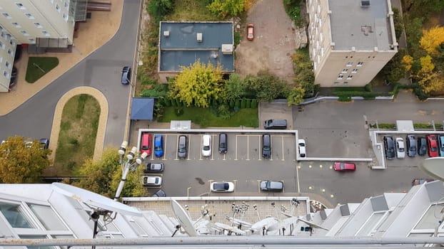 Empty parking lots in front of buildings, aerial view. Courtyard of a residential high-rise building, view from the roof of the house.