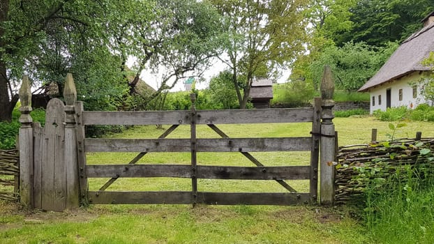 Closed wooden gate from the boards in the village or village. Vintage style design