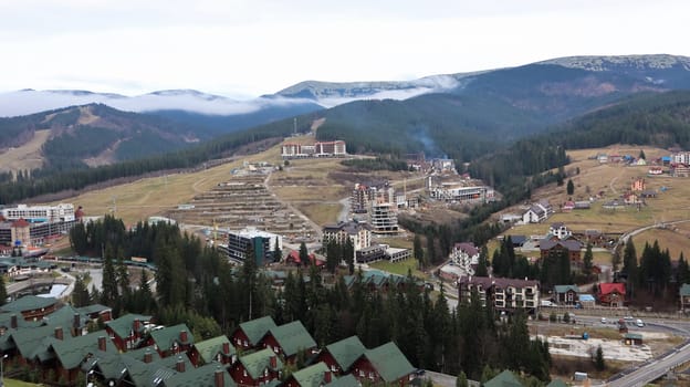 Bukovel ski resort in autumn aerial view. View of hotel houses in the ecological countryside against the background of spruce trees and mountain hills.Ukraine, Bukovel - November 20, 2019