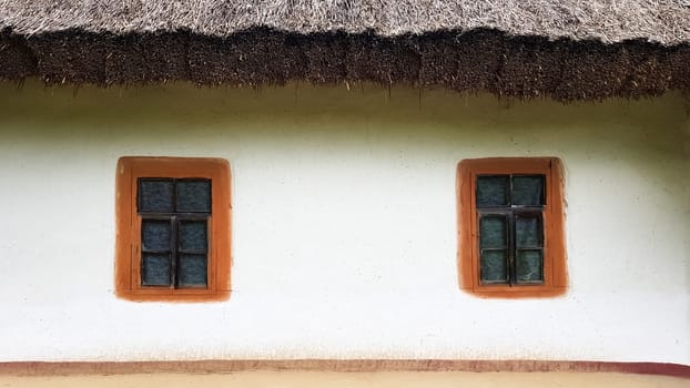 Ukraine, Kiev - June 11, 2020. Old window in a vintage traditional peasant house in Ukraine. Antique wooden window frame. Pirogovo National Museum in the open air in Kiev. Copy space