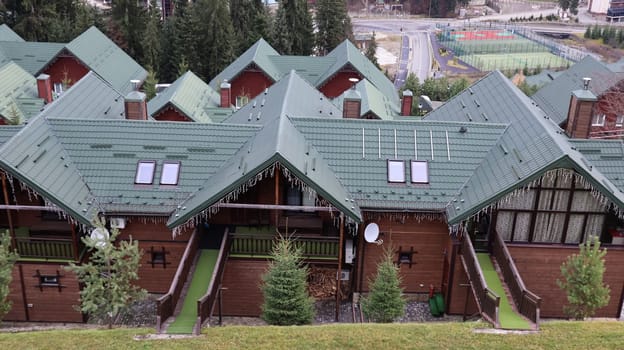 Bukovel ski resort in autumn aerial view. View of hotel houses in the ecological countryside against the background of spruce trees and mountain hills.Ukraine, Bukovel - November 20, 2019