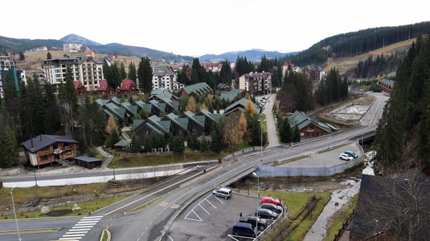 Bukovel ski resort in autumn aerial view. View of hotel houses in the ecological countryside against the background of spruce trees and mountain hills.Ukraine, Bukovel - November 20, 2019