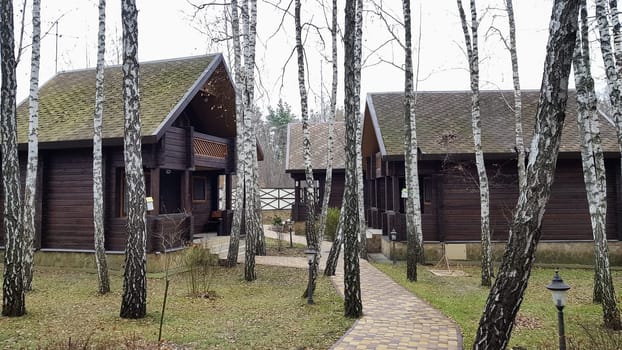 Ukraine, Kiev - April 17, 2020. A country hotel with brown wooden guest houses. Cottage village. The construction of mysterious houses. Infrastructure. To live and relax in the country