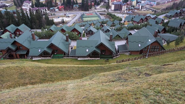 Bukovel ski resort in autumn aerial view. View of hotel houses in the ecological countryside against the background of spruce trees and mountain hills.Ukraine, Bukovel - November 20, 2019