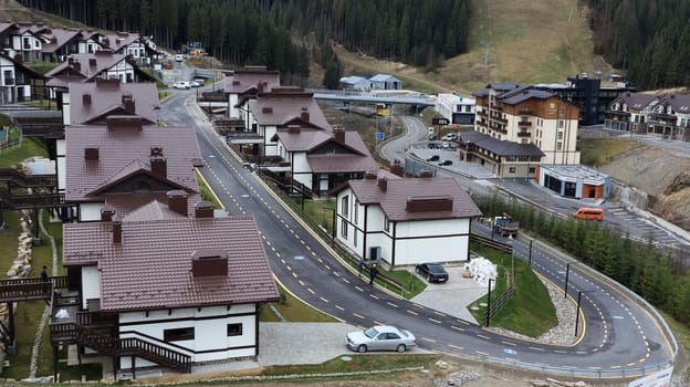 Bukovel ski resort in autumn aerial view. View of hotel houses in the ecological countryside against the background of spruce trees and mountain hills.Ukraine, Bukovel - November 20, 2019