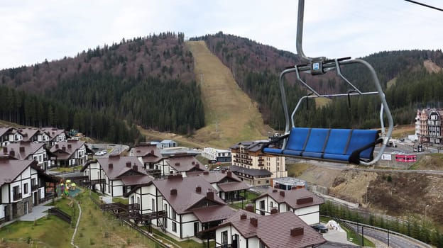 Ukraine, Bukovel - November 20, 2019. Autumn view of the ski resort with a chairlift against the background of autumn mountain slopes and the infrastructure under construction of a winter ski resort