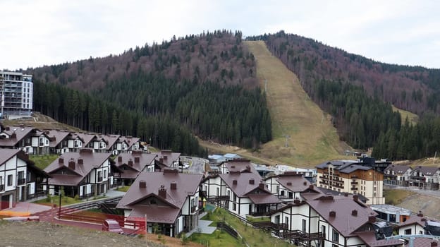 Bukovel ski resort in autumn aerial view. View of hotel houses in the ecological countryside against the background of spruce trees and mountain hills.Ukraine, Bukovel - November 20, 2019
