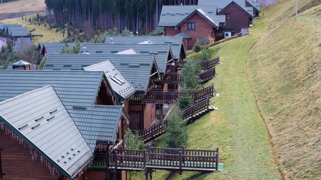 Bukovel ski resort in autumn aerial view. View of hotel houses in the ecological countryside against the background of spruce trees and mountain hills.Ukraine, Bukovel - November 20, 2019