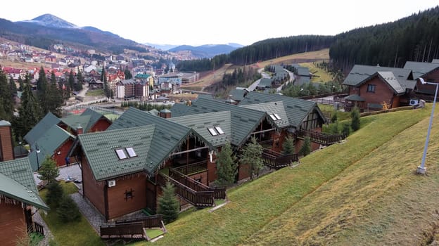 Bukovel ski resort in autumn aerial view. View of hotel houses in the ecological countryside against the background of spruce trees and mountain hills.Ukraine, Bukovel - November 20, 2019