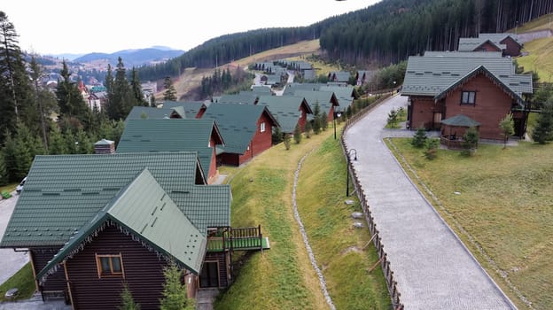 Bukovel ski resort in autumn aerial view. View of hotel houses in the ecological countryside against the background of spruce trees and mountain hills.Ukraine, Bukovel - November 20, 2019
