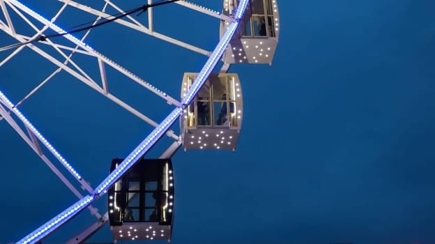 Ukraine, Kiev - January 15, 2019. Illuminated Ferris Wheel on Kontraktova Square in Kiev in the evening
