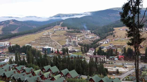 Bukovel ski resort in autumn aerial view. View of hotel houses in the ecological countryside against the background of spruce trees and mountain hills.Ukraine, Bukovel - November 20, 2019