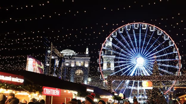 Ukraine, Kiev - January 15, 2019. Illuminated Ferris Wheel on Kontraktova Square in Kiev in the evening