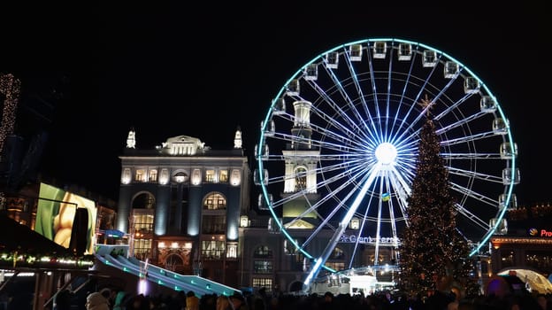 Ukraine, Kiev - January 15, 2019. Illuminated Ferris Wheel on Kontraktova Square in Kiev in the evening