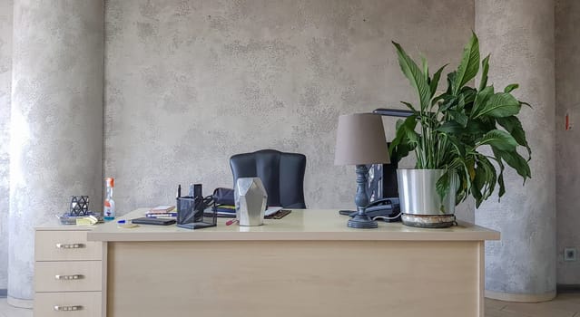 design of a workplace in the office with modern equipment and amenities on a gray wall background