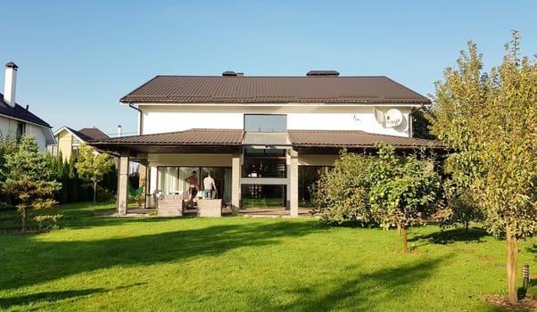 Ukraine, Kiev - September 24, 2019: Facade of a new modern house in the Australian style. Luxury Villa Resort Interior. Large luxury custom house with a beautifully maintained and landscaped front lawn in a suburb