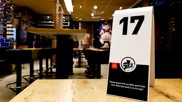 Ukraine, Kiev - September 9, 2019 - 17 order number on the table in the McDonald's restaurant. Awaiting order at McDonald's Restaurant.