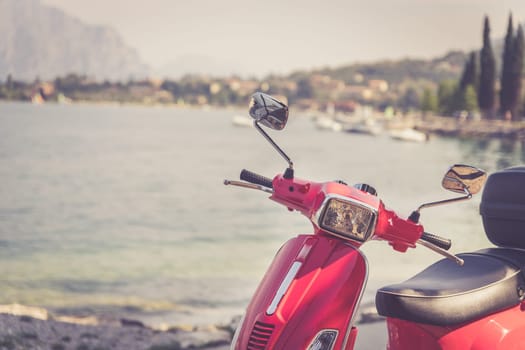 Beautiful red scooter on the beach, landscape and blue sky