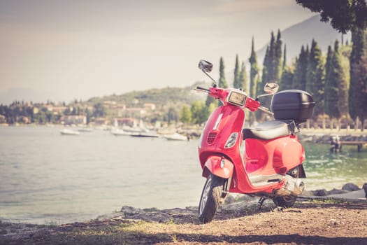 Beautiful red scooter on the beach, landscape and blue sky