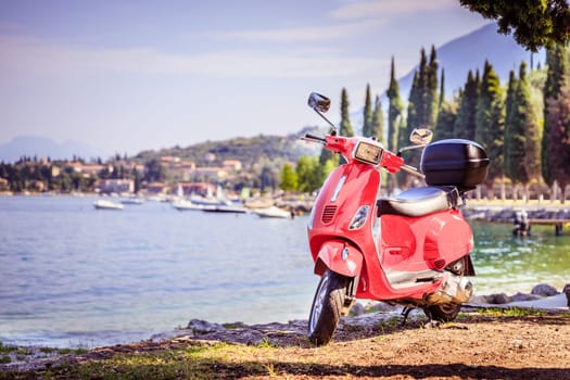 Beautiful red scooter on the beach, landscape and blue sky