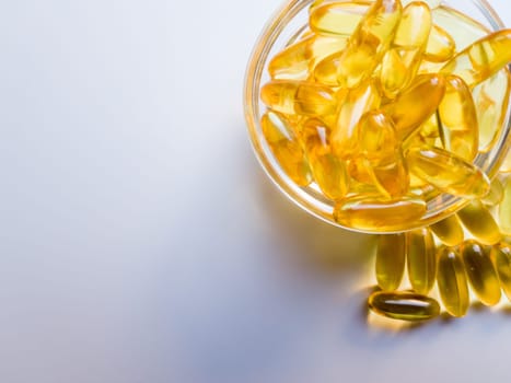 Fish oil capsules on a glass plate. A lot of vitamin omega 3 on a white background. Close-up, top view, high resolution product. Metabolism in the body. The body of calcium. A quick way to lose weight.