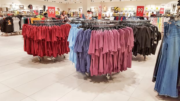 Ukraine, Kiev - September 04, 2019: A large clothing store, mannequins and many rows with hangers, a variety of sizes and colors. Black Friday, a day of shopping and sales at boutiques and malls.