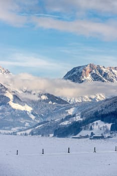 Snowy mountains, meadow and fence, landscape in Austria, panorama