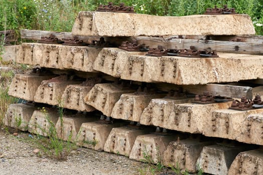 old no longer used overgrown and discarded railroad sleepers in a storage yard