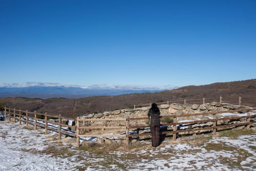 Visitor observing an old Corral de Lobos or Wolves trap. La Garganta, Extremadura, Spain