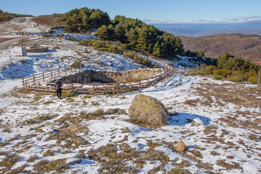 Visitor observing an old Corral de Lobos or Wolves trap. La Garganta, Extremadura, Spain