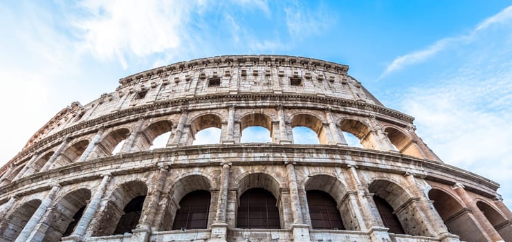 Detail of Colosseum in Rome (Roma), Italy. Also named Coliseum, this is the most famous Italian sightseeing. Spectacular blue sky in background.