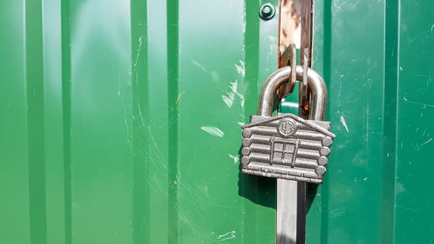 metal door with lock, texture and background. Background texture of an iron padlock on a rusty metal gate