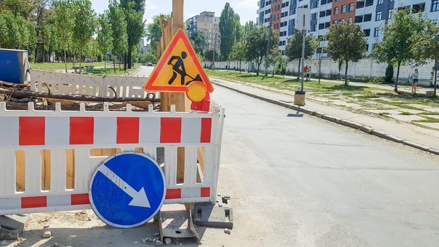 Ukraine, Kiev - October 1, 2019: Repair work of roads in the streets. Construction site of city streets with barricades and protective fences, roadworks and detour signs