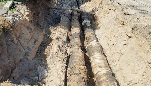 District reconstruction of the street of the district heating pipeline and the replacement of old pipes with new ones. Heating main construction for urban infrastructure, city development concept