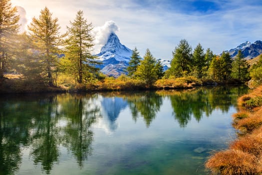 Famous alpine peak Matterhorn refleced in a pond in Swiss Apls