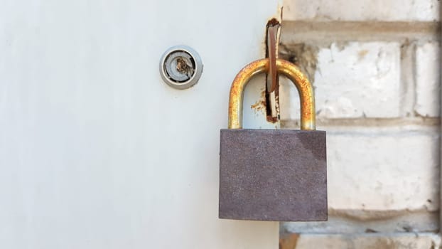 metal door with lock, texture and background. Background texture of an iron padlock on a rusty metal gate