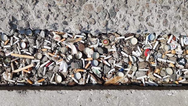A lot of cigarette butts. The cause of lung cancer. Many used cigarette butts as trash.