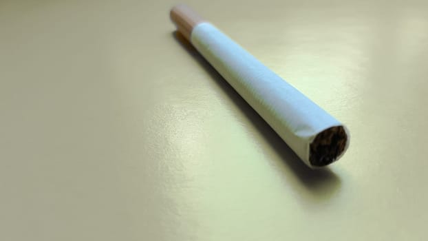 Cigarettes isolated diagonal on a yellow background.