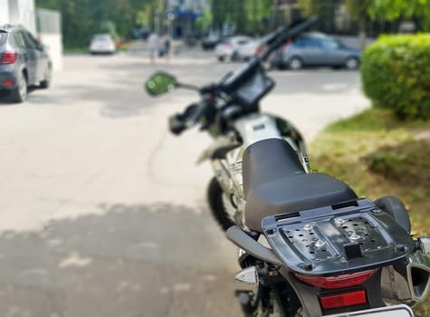 Black motorcycle parked. Back view. Soft focus.