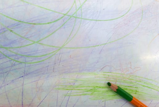 color pencils with drawn colored lines isolated on white background. Top view. Hand drawn scribble smears on paper.